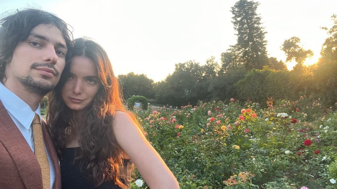 Dylan Gelula and her boyfriend Devon Bostick in a garden.