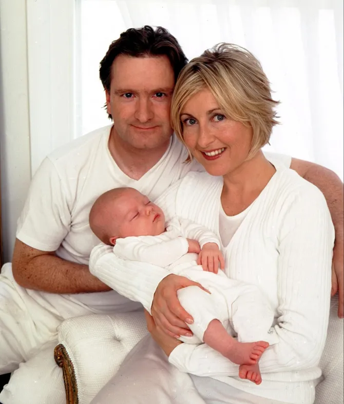 Fiona Phillips and her spouse with their newborn.