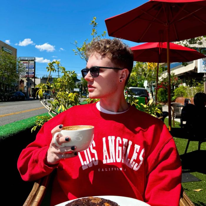 Jessica Lord's younger brother drinking coffee.